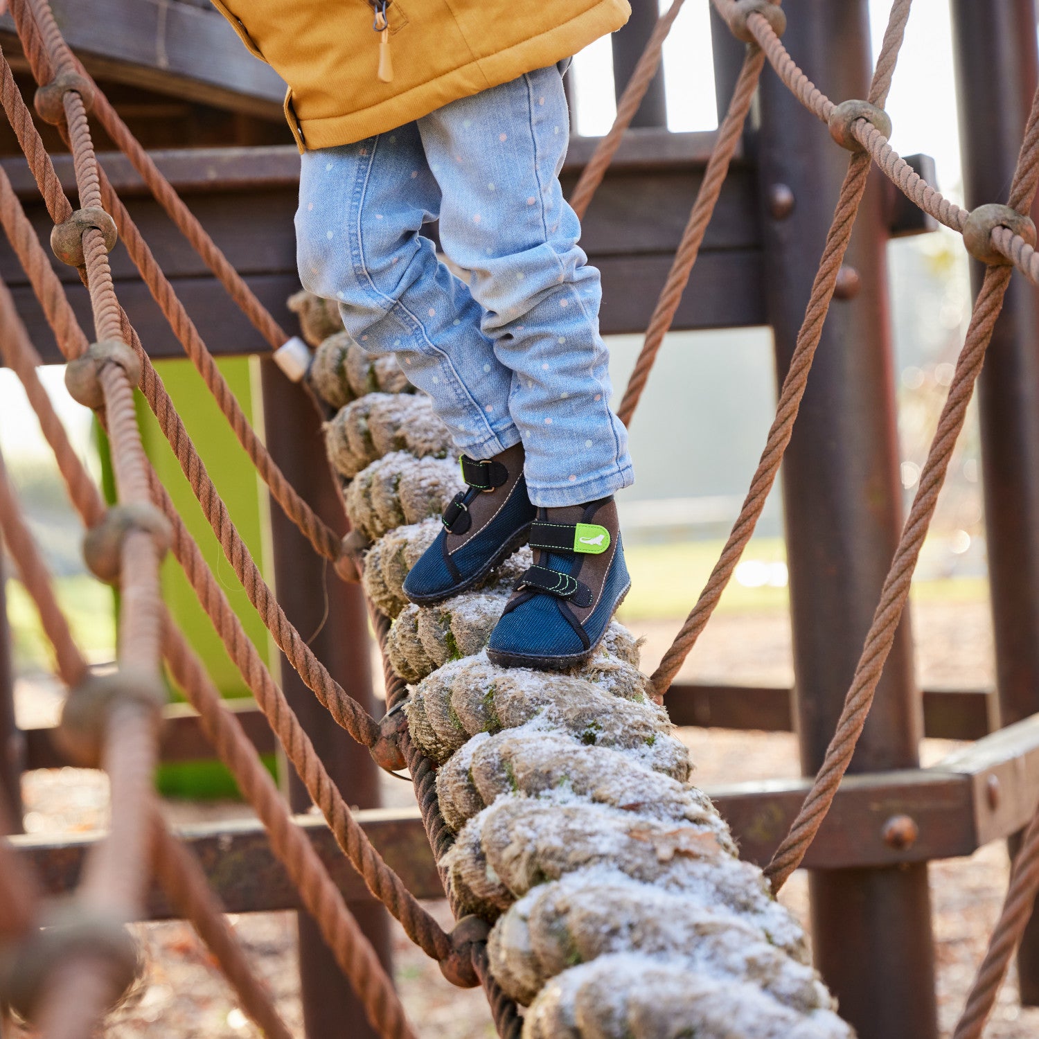 Leguanito Scippo Klett Kinder Barfußschuhe in wasserabweisender Ausführung – Ein Kind spielt fröhlich im Freien, während es die funktionalen und bequemen Barfußschuhe trägt. Die elastische Passform und der Klettverschluss sorgen für einen perfekten Sitz und viel Bewegungsfreiheit. Erhältlich bei barfusswelteb.com.